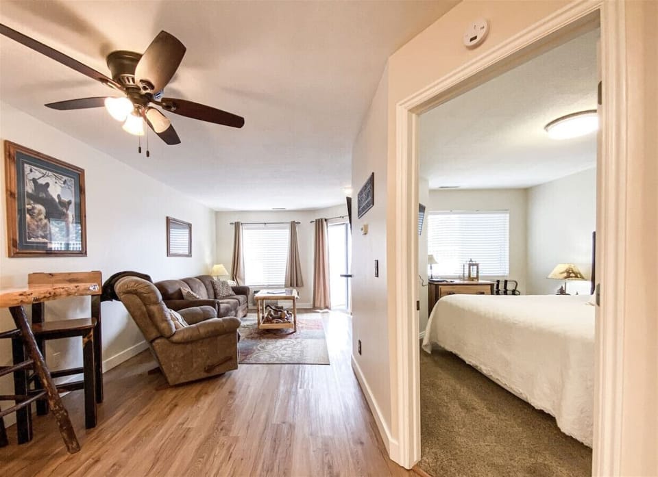 Warm, open-concept layout with cozy seating and natural light for a relaxing, homey retreat.