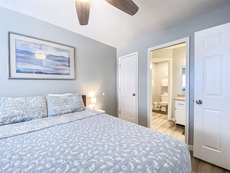 Relaxing bedroom with plush bedding and adjacent bath
