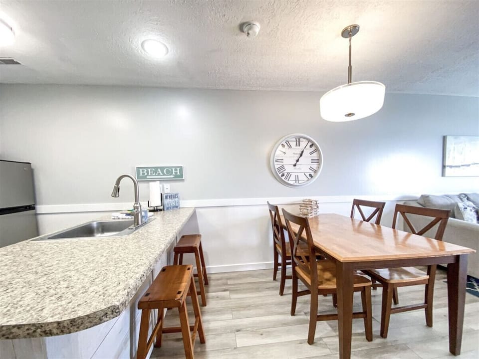 Open dining and kitchen area with breakfast bar seating