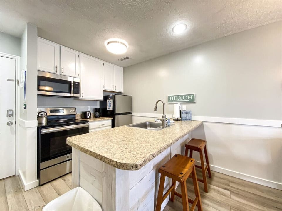 Functional kitchen with breakfast bar seating and updated appliances