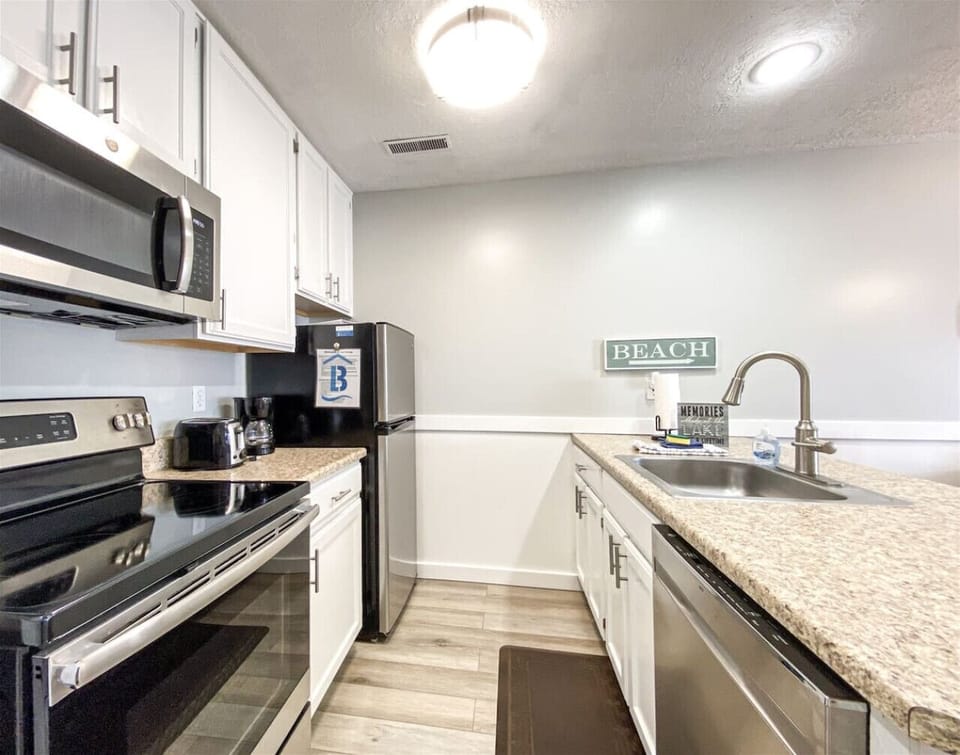 Bright kitchen featuring stainless appliances and plenty of prep space