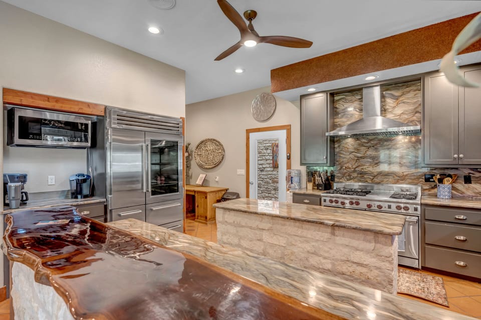 Large refrigerator and a double oven gas stove.