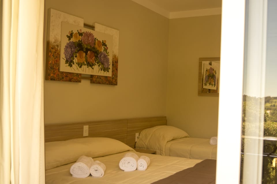 Luxury Triple Room | Minibar, blackout drapes, free WiFi, bed sheets