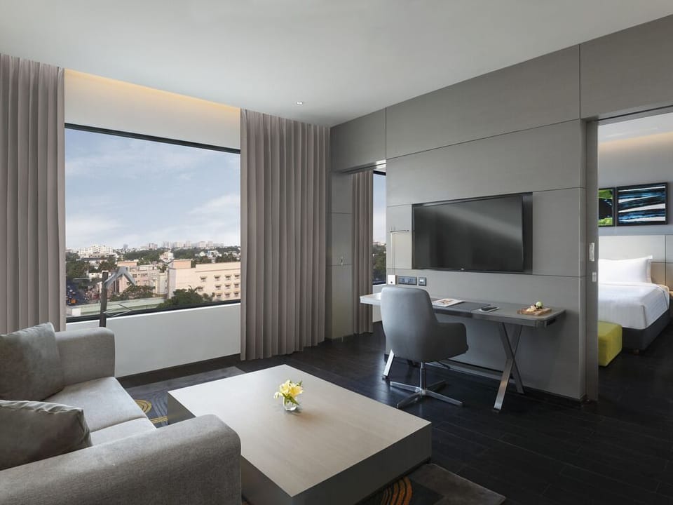 Luxury Suite with One Way Airport Transfer, Separate Living Room and Bathtub | Minibar, in-room safe, desk, blackout drapes