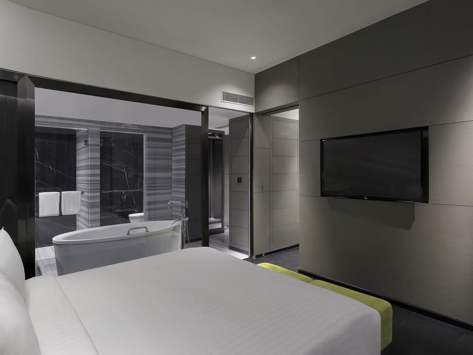 Luxury Suite with One Way Airport Transfer, Separate Living Room and Bathtub | Minibar, in-room safe, desk, blackout drapes