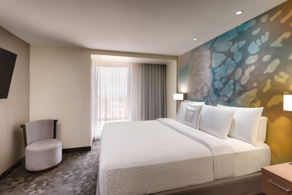 Premium bedding, desk, laptop workspace, iron/ironing board