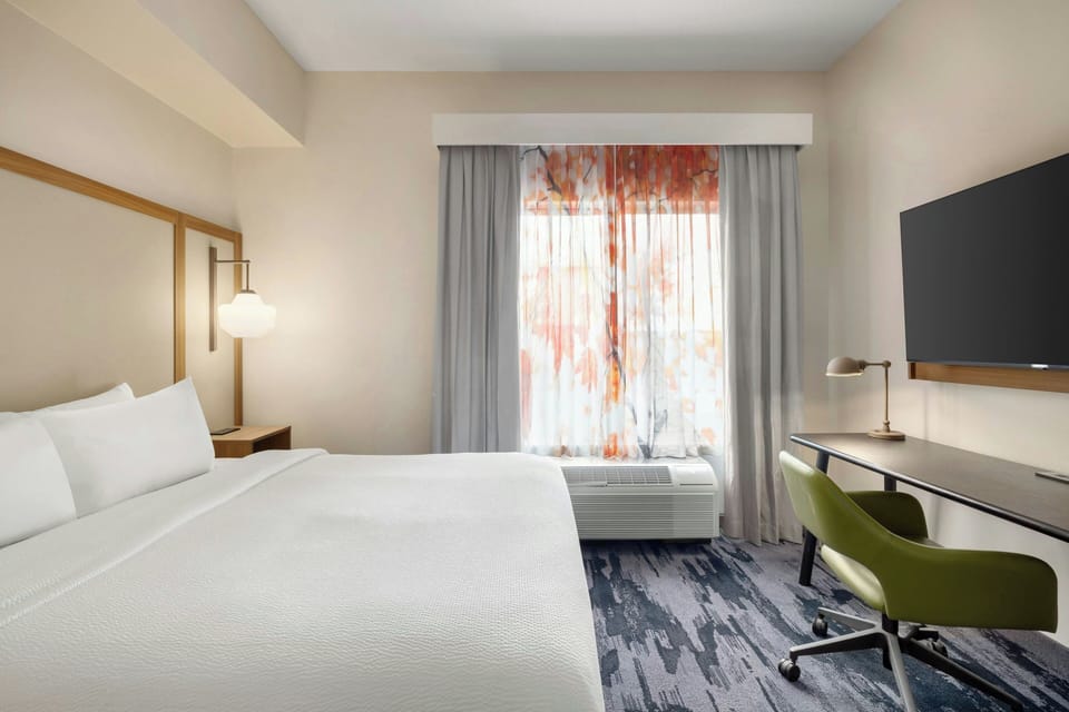 Premium bedding, desk, laptop workspace, iron/ironing board