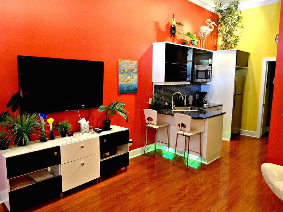 Living room 75"  Smart TV, laminate floors, recessed lights, 14 ft ceiling
