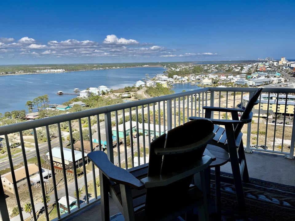 King Guest Bedroom Balcony with Two Bar Height Chairs Overlooking Little Lagoon