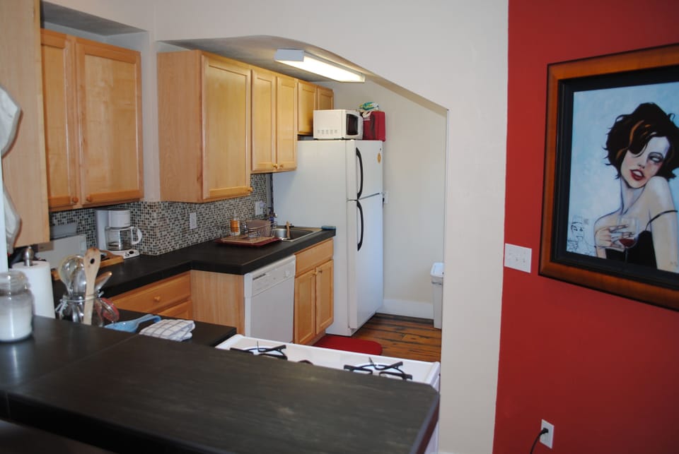 The kitchen has hard surface counters and bar along with a gas range