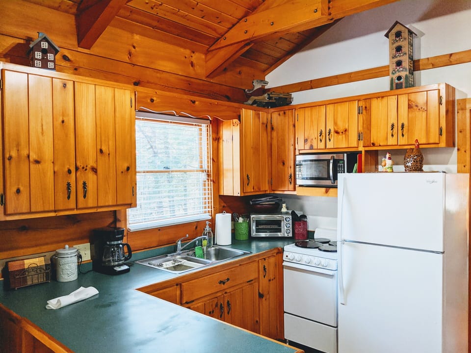 The kitchen with stove, microwave, full-size fridge and full kitchen amenities. 