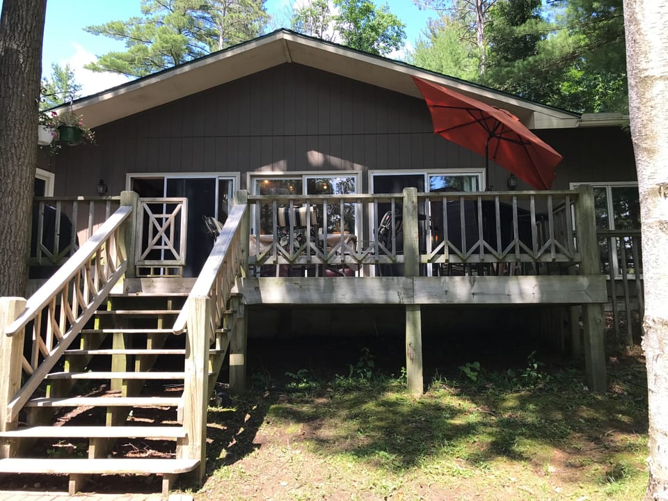 Walkout sliders to a large deck overlooking Lake Bobidosh, grill, table & chairs