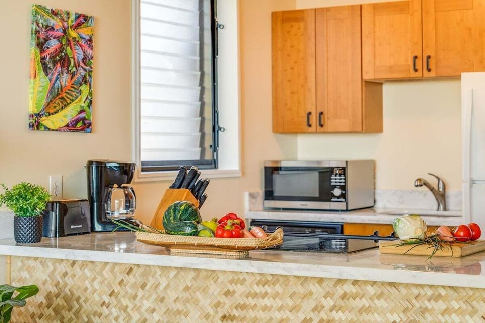 A well‑equipped kitchen counter with everyday essentials and fresh ingredients ready for simple vacation cooking.