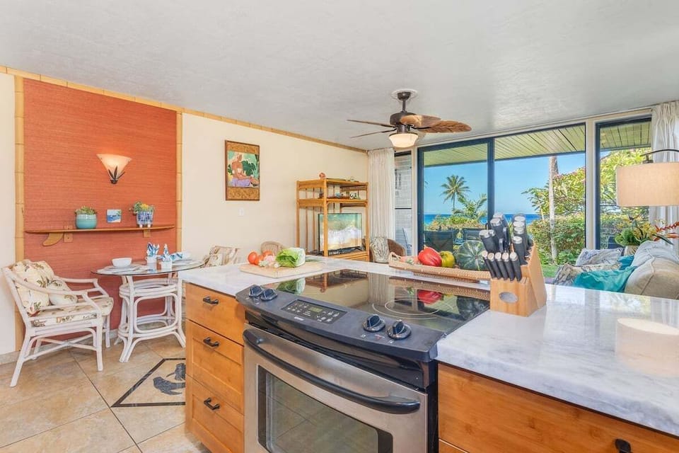A sunny dining area with garden views, tropical accents, and an easy flow from kitchen to table.