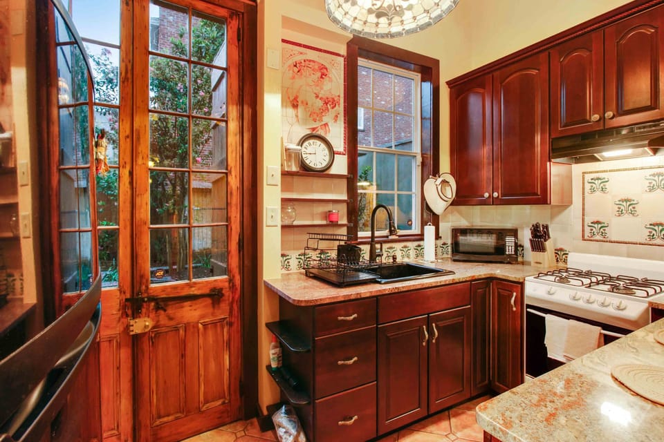 Original French doors with stain glass transom looking out into the courtyard. 