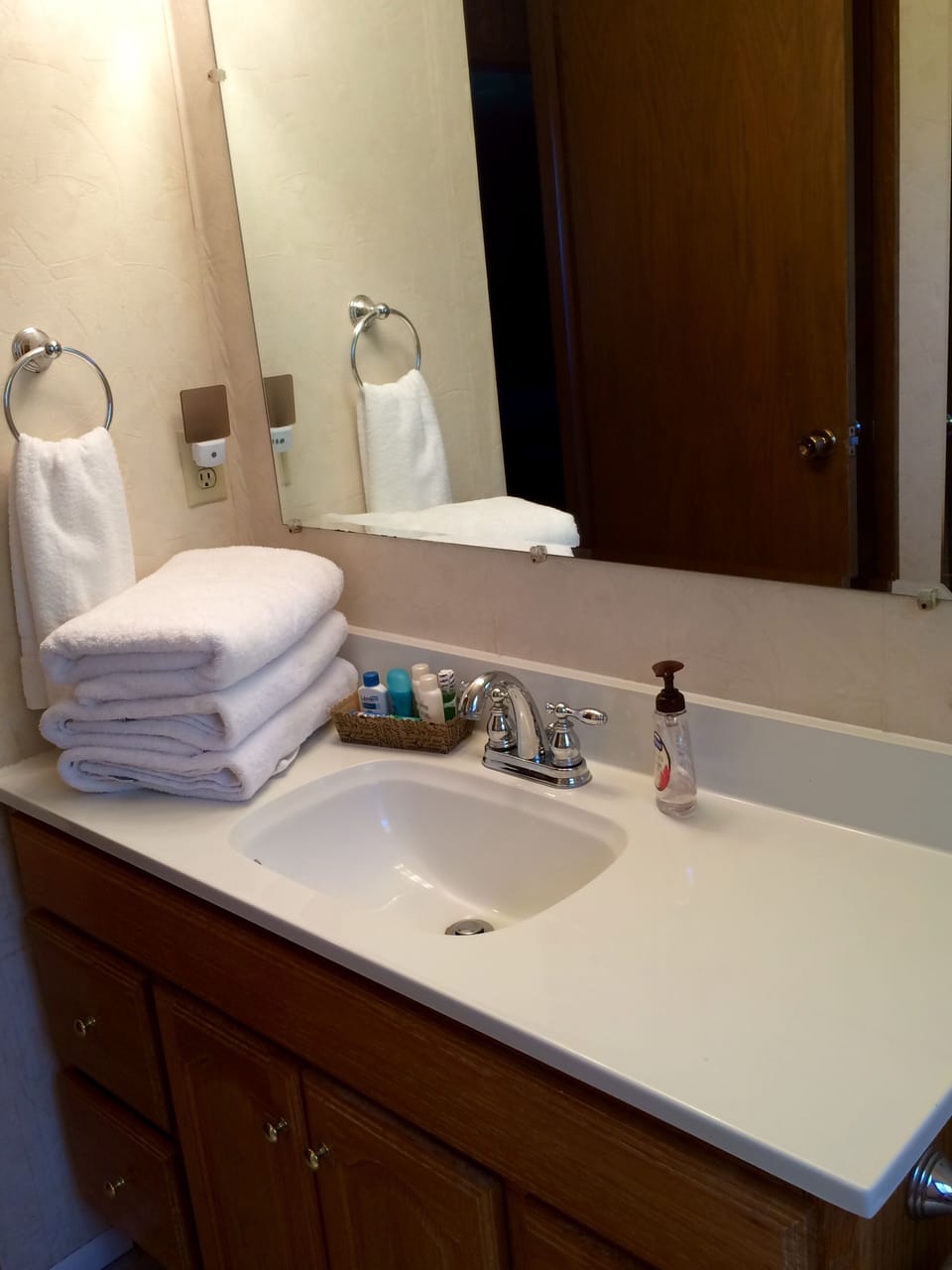 The large, main floor bath is fully stocked with clean, fluffy towels .