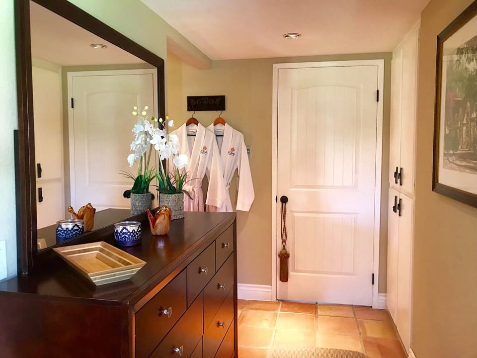 Large Dresser with mirror between bedroom and bath. Robes - the luxurious touch!