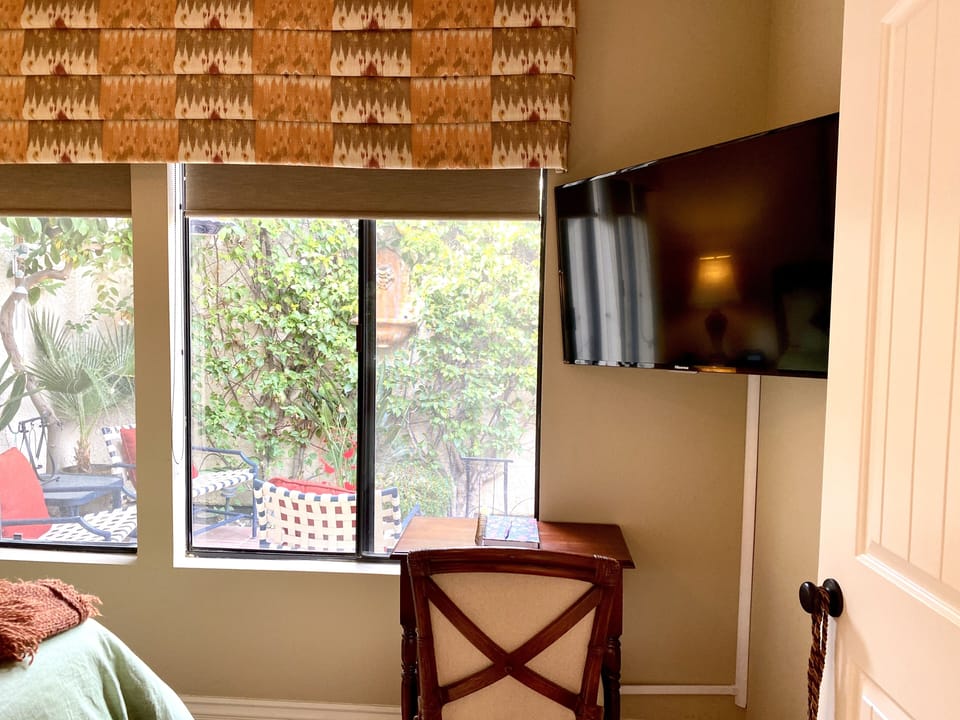 Large screen TV and a desk with a view.
This master has double doors and dresser