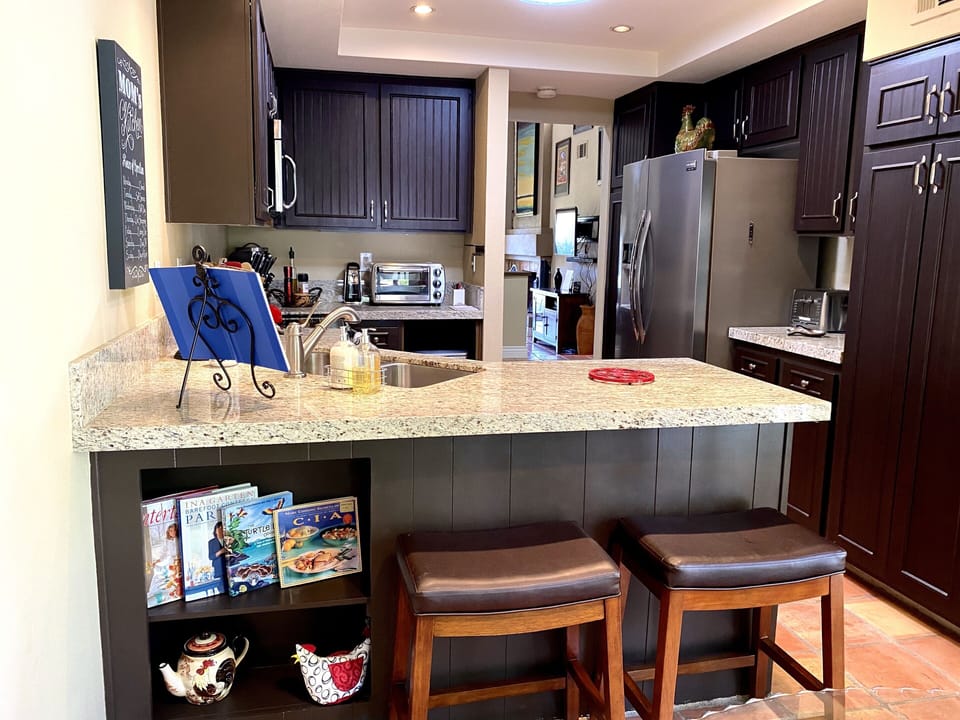 Gathering place. Barstools for friends to keep you company while you/they cook.