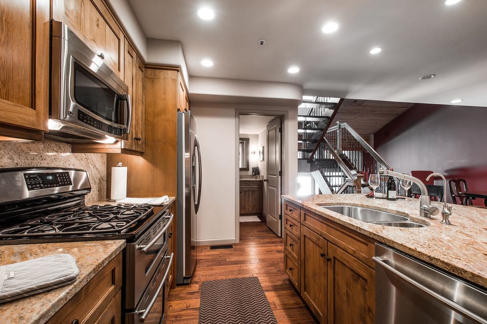 Kitchen showing stairs to living and bedrooms and bathroom