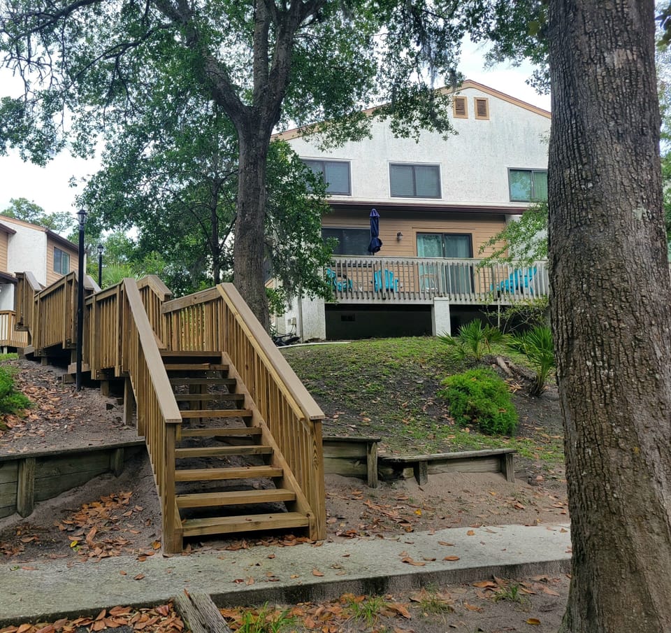 Entry boardwalk with a spacious balcony and adirondack chairs to relax in.