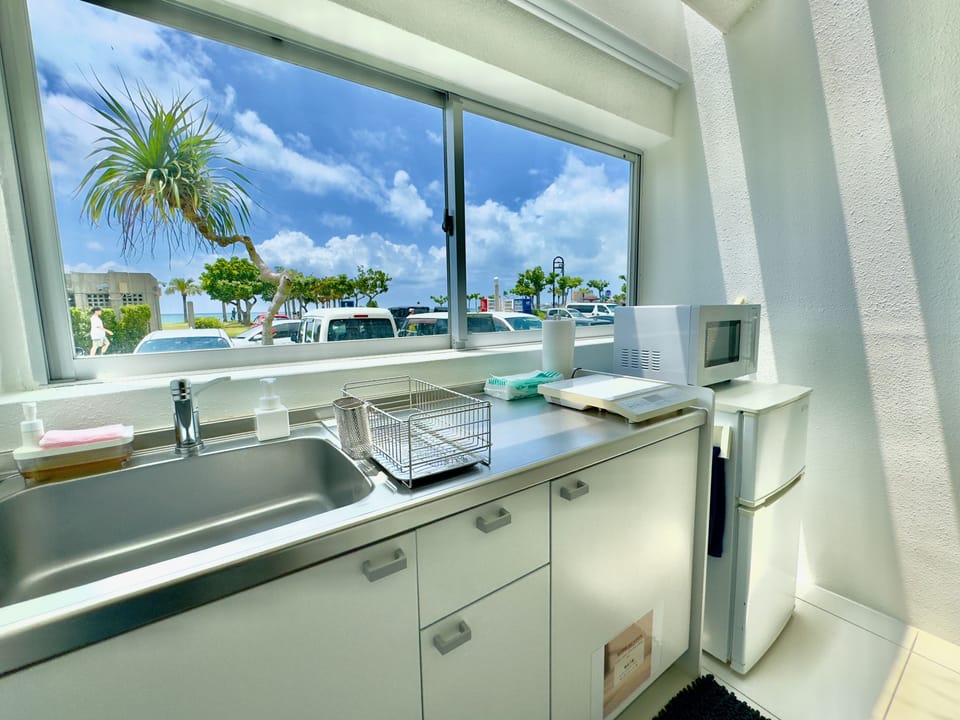Economy Condo, Beachfront | Private kitchen | Fridge, cookware/dishes/utensils