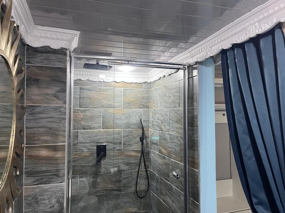 Shower, rainfall showerhead, hair dryer (on request), towels