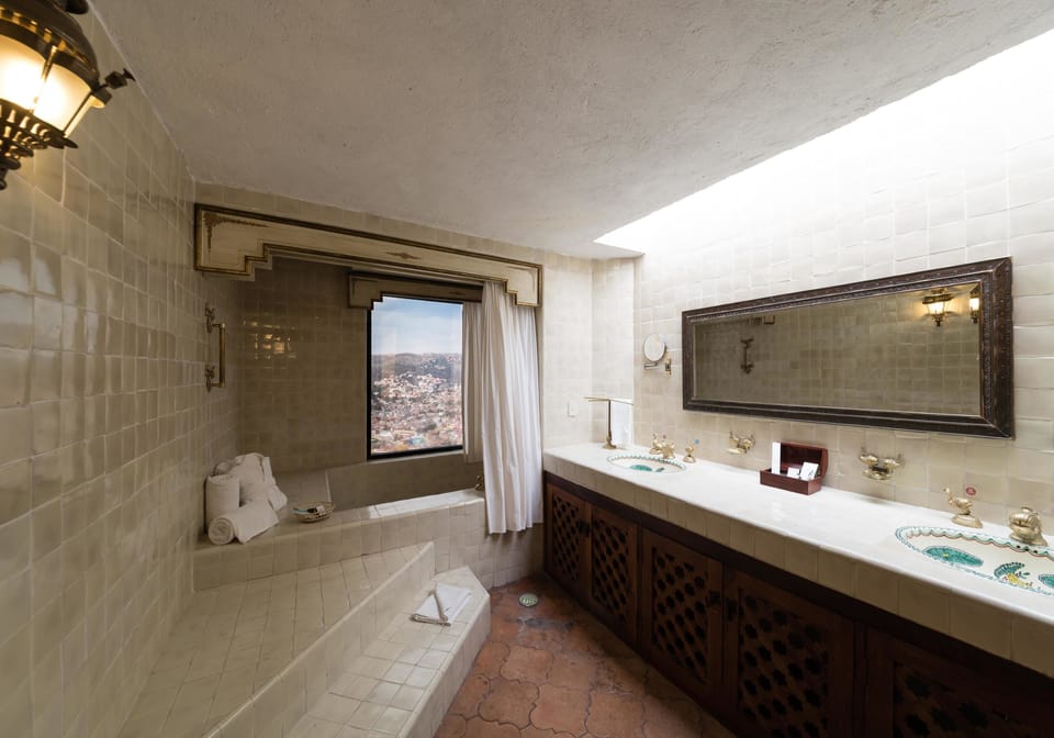 Shower, designer toiletries, hair dryer, towels