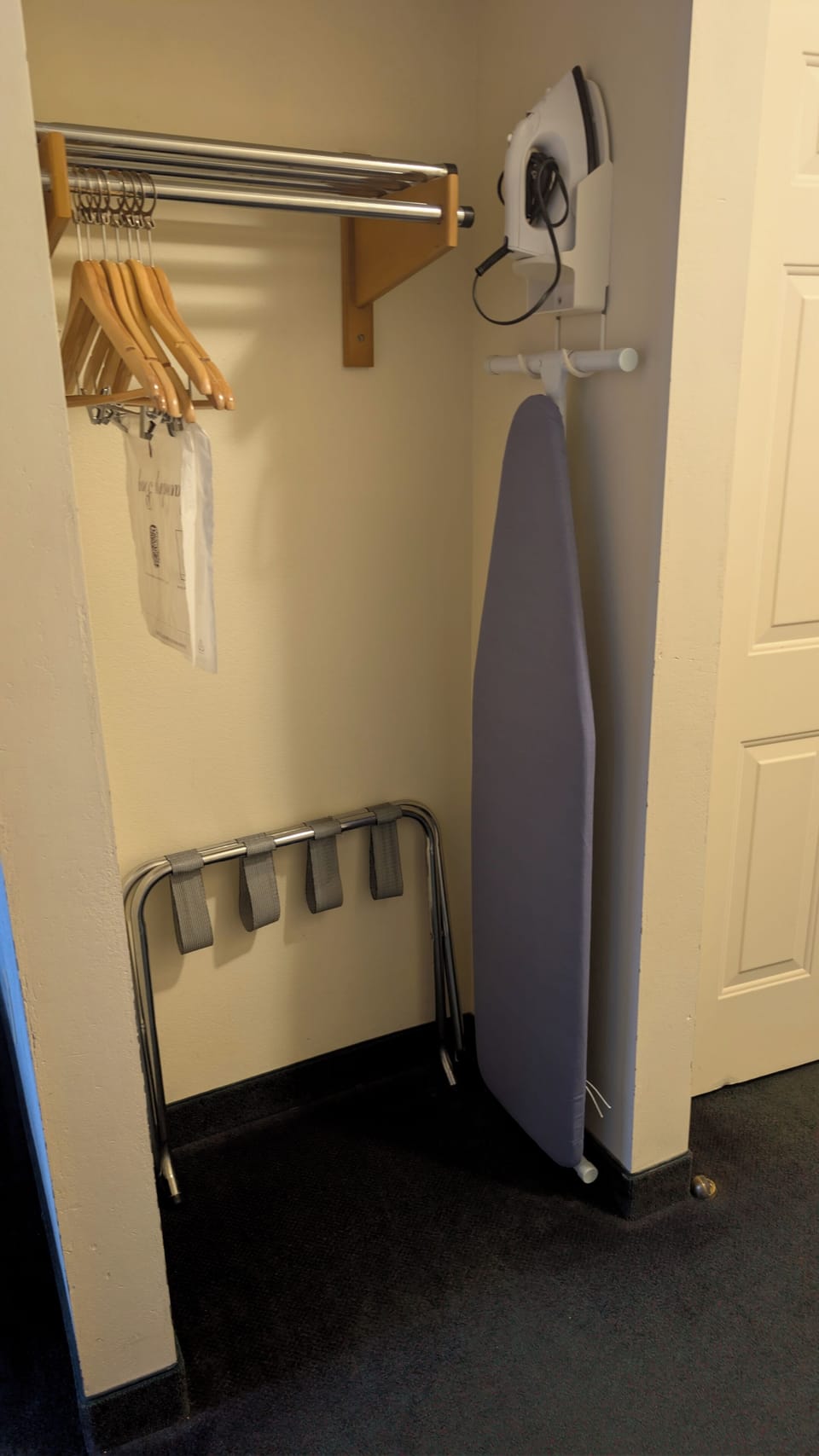 Desk, iron/ironing board, bed sheets