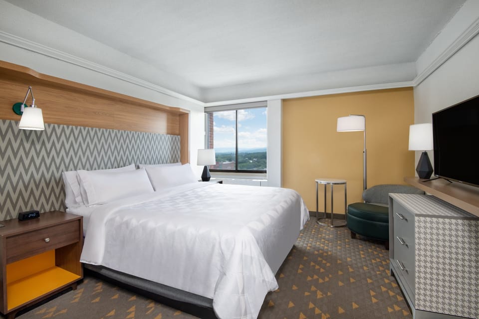 Hypo-allergenic bedding, desk, laptop workspace, blackout drapes