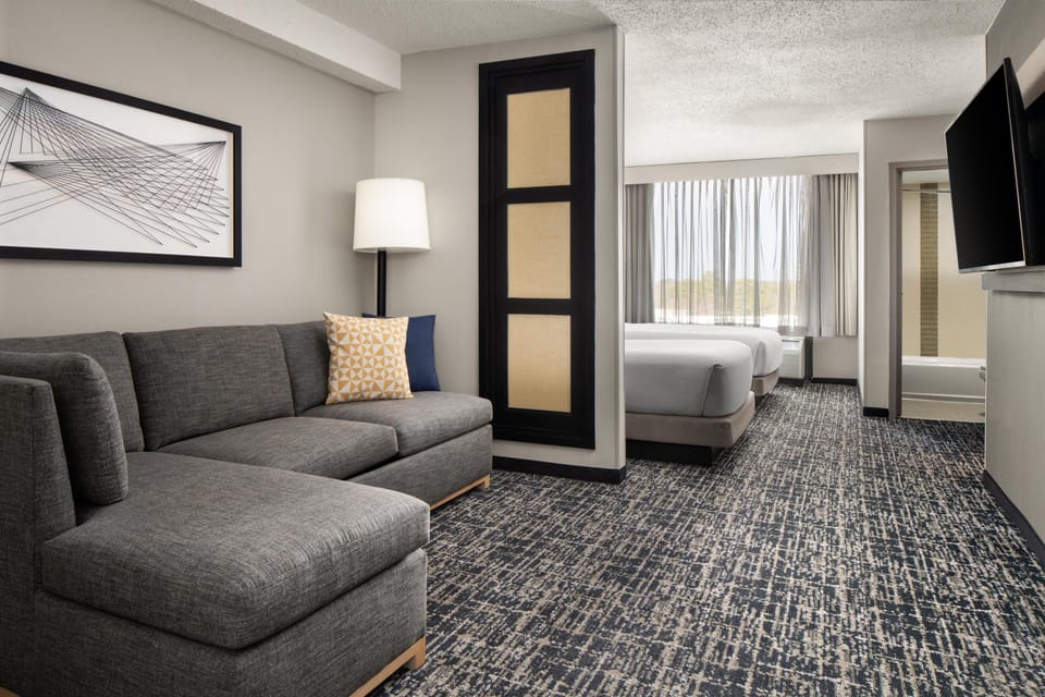 Premium bedding, desk, laptop workspace, blackout drapes
