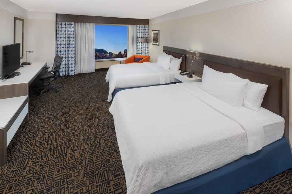 Premium bedding, in-room safe, laptop workspace, soundproofing