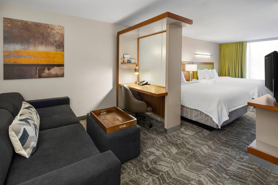 Premium bedding, desk, laptop workspace, blackout drapes