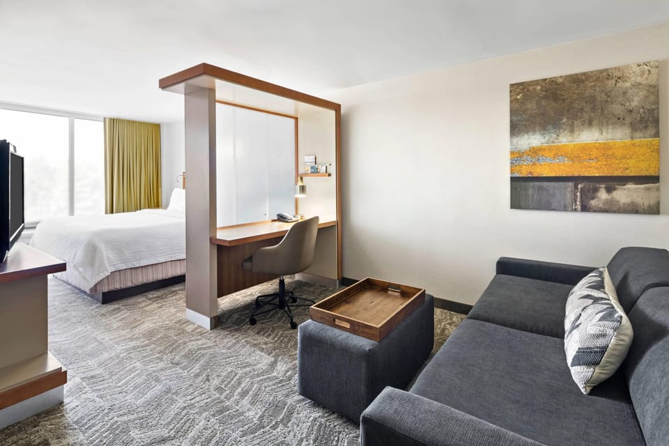 Premium bedding, desk, laptop workspace, blackout drapes