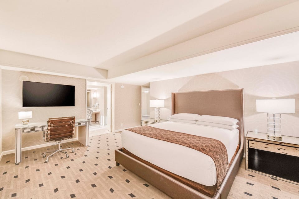 Premium bedding, desk, laptop workspace, blackout drapes