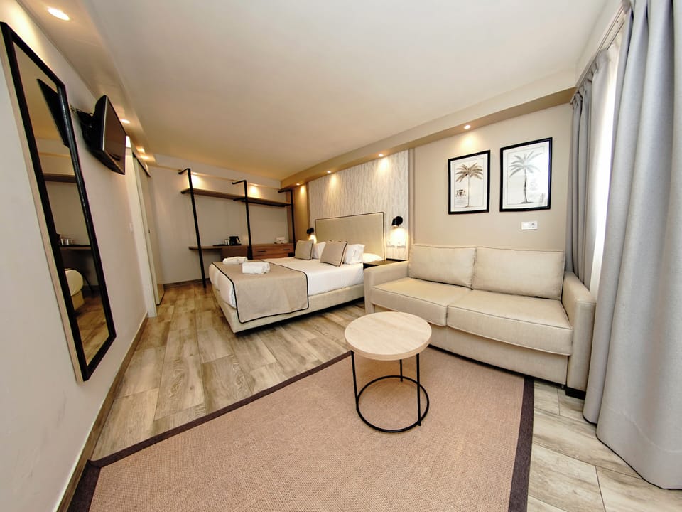 Comfort Quadruple Room with Free Airport Shuttle | Down comforters, minibar, in-room safe, individually decorated