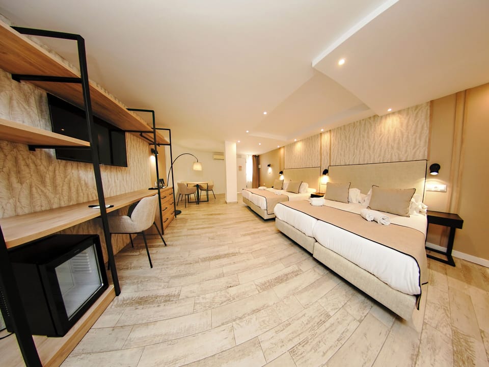 Deluxe Quadruple Room with Free Airport Shuttle | Down comforters, minibar, in-room safe, individually decorated