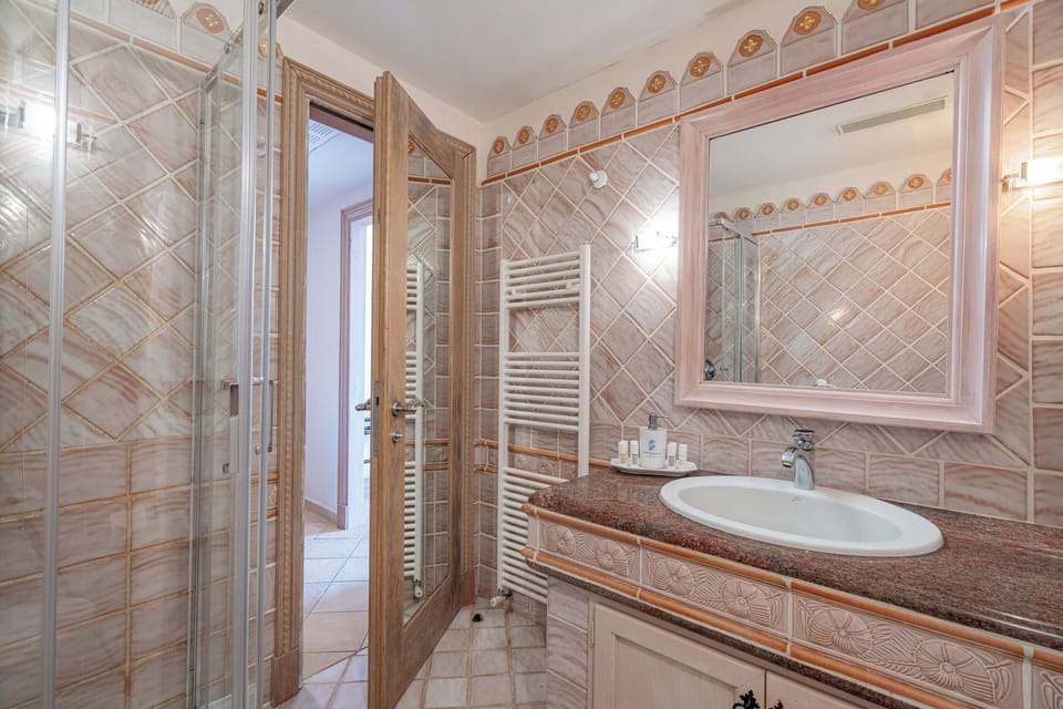 Shower, designer toiletries, hair dryer, slippers