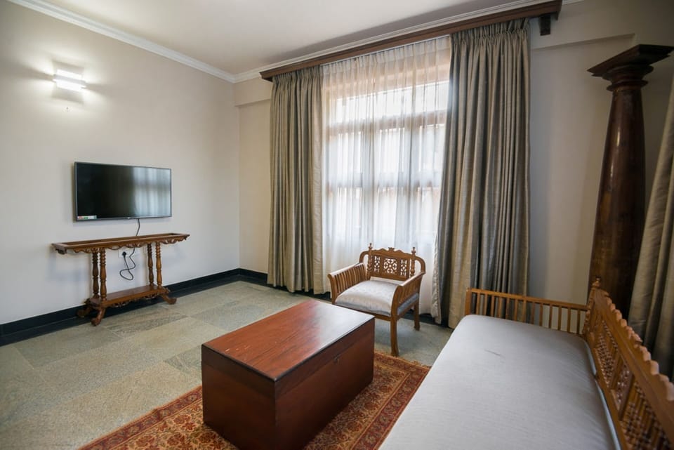 Millennium Suite | Living area | 43-inch flat-screen TV with satellite channels, TV