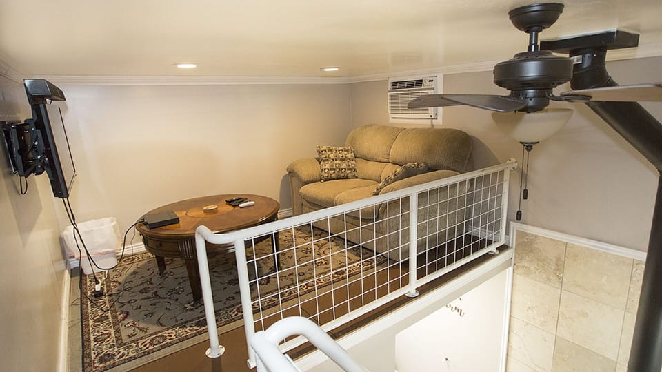Enjoy the remote controlled AC unit while watching your favorite movie on the cozy couch.