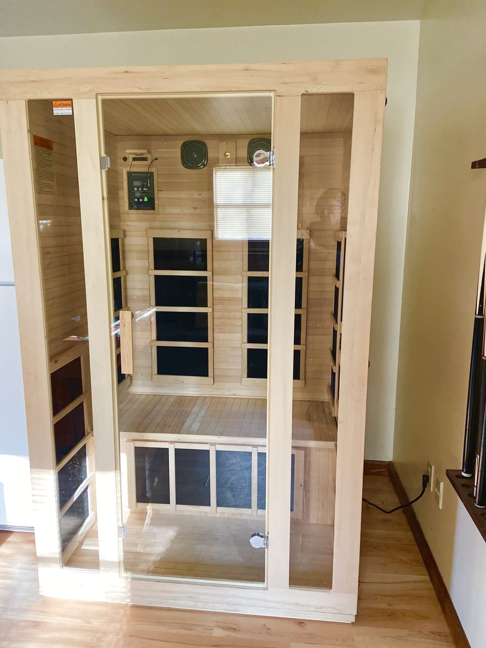 Sauna and spare refrigerator in the game room. 