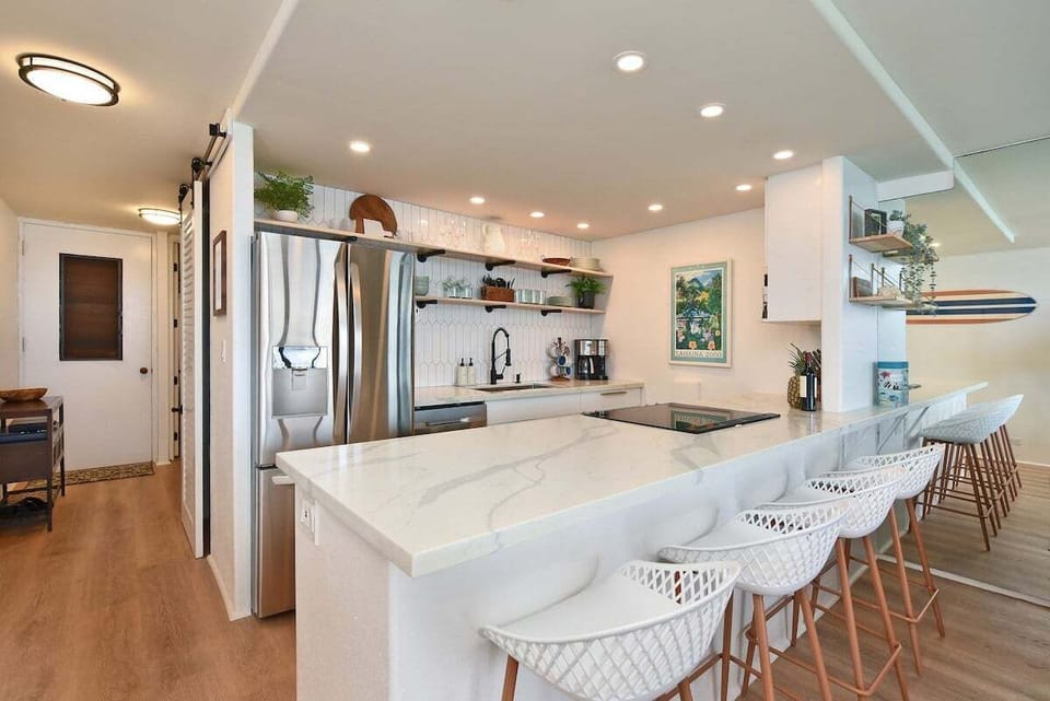 Fully equipped kitchen featuring quartz countertops and bar seating, ideal for quick breakfasts