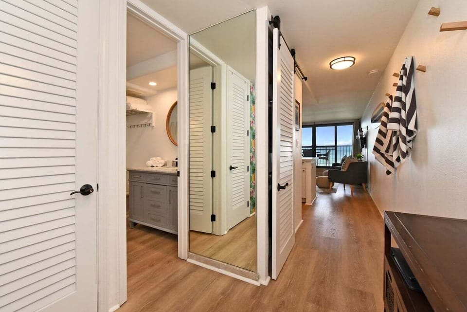 Stylish entryway with bathroom access and ocean light, perfect for relaxed indoor-outdoor living