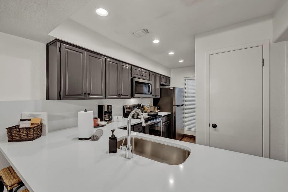 automatic drip coffee maker, coffee, sugar, and creamer are provided 