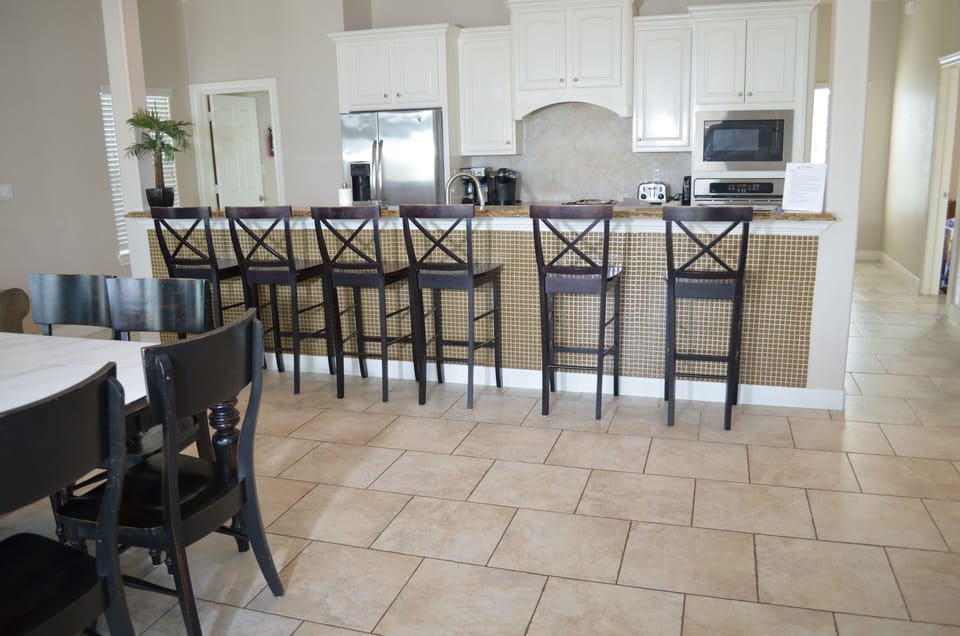 Additional seating at long granite counter, looking into kitchen