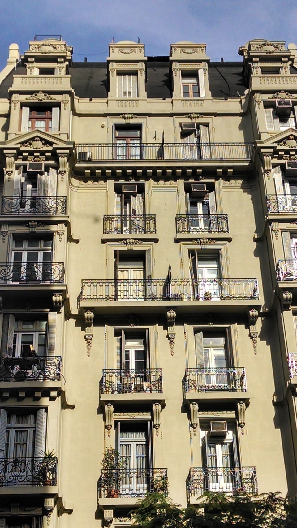 The apartment on the top left has 2  balconies on the left, before the top.