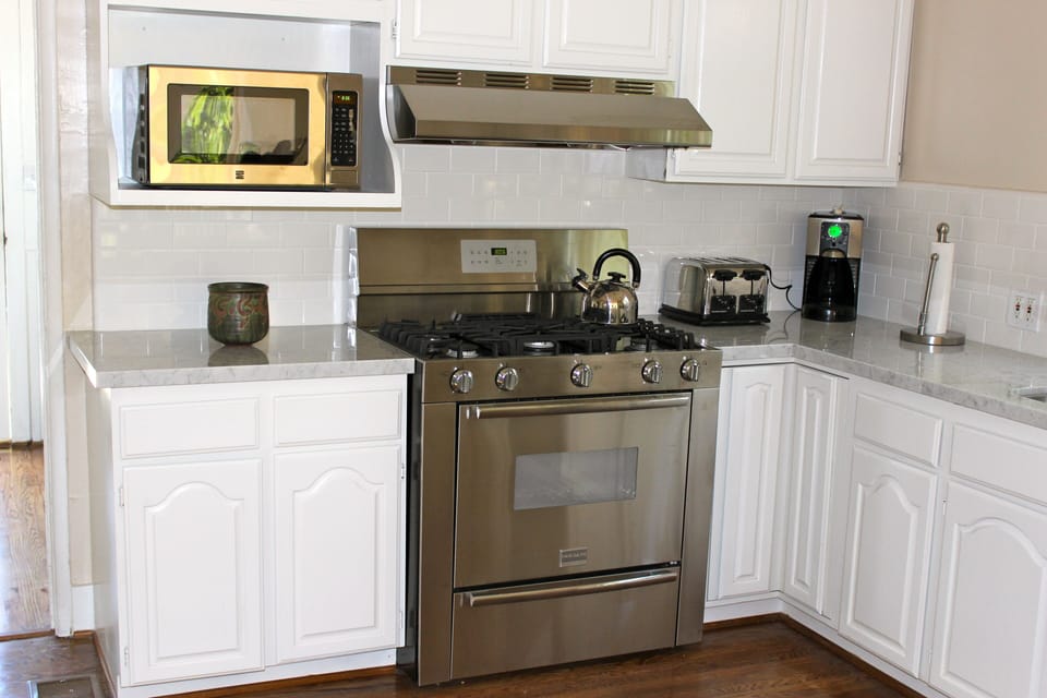 Kitchen with stainless steel appliances and marble countertops.