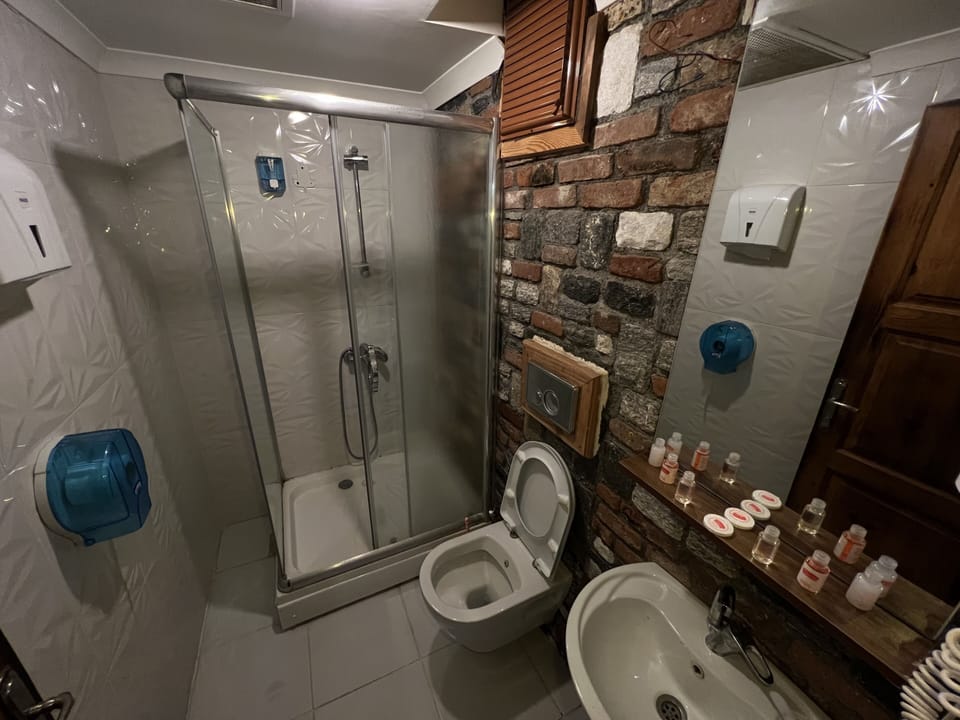 Shower, designer toiletries, hair dryer, slippers