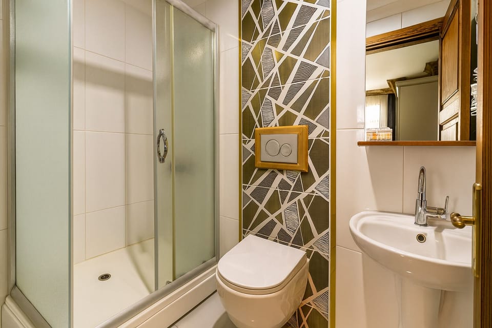 Shower, designer toiletries, hair dryer, slippers
