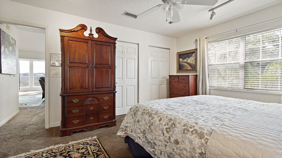 Bedroom and storage cabinet with smart TV inside.
